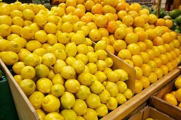 Wooden Bins Filled with Fresh Lemons and Oranges