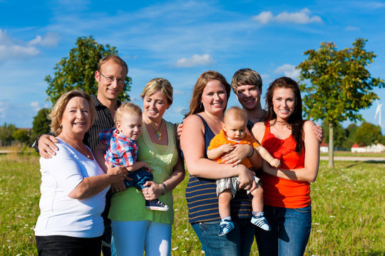 Family and multi-generation - fun on meadow in summer