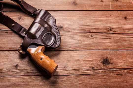 pistol on a wood background