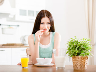 Obraz na płótnie Canvas Portrait of the girl eating healthy muesli