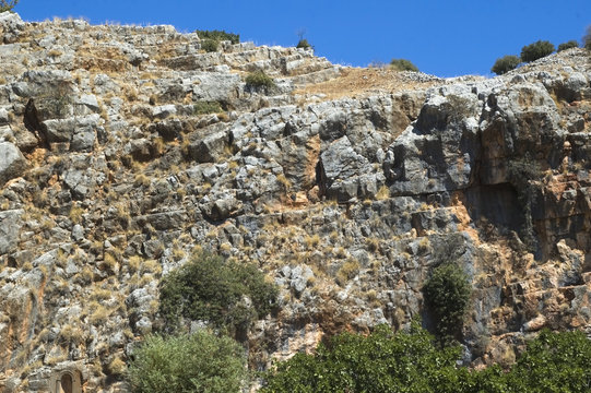 A rock wall against a blue sky
