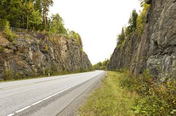 Highway among granite rocks in early autumn.