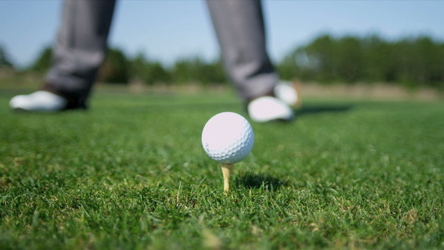 Professional Golfer Teeing Off