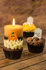 Halloween cupcakes and a burning candle close-up