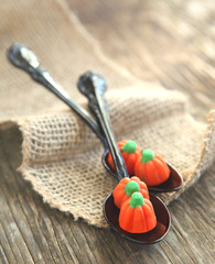 Pumpkin candy in black spoon