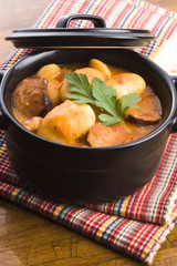 Beans with sausage, bacon and tomatoes