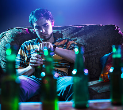 Young Man Drinking Beer Alone