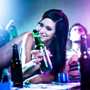 Girl At Drug Fueled House Party With Beer Bottle.