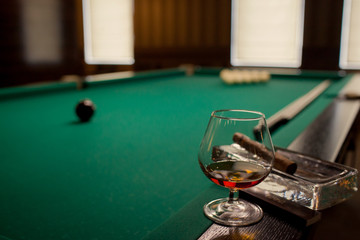 glass of cognac and billiards