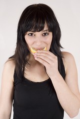 attractive young woman eating citrus fruit