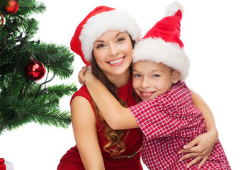 happy mother and child boy in santa helper hats