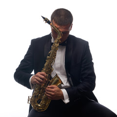 Naklejka premium Isolated portrait of sitting saxophonist in tuxedo