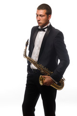 Fototapeta na wymiar Isolated portrait of young saxophonist in suit with tie