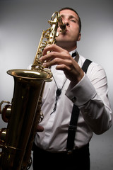 closeup portrait of playing saxophonist. Wide angle