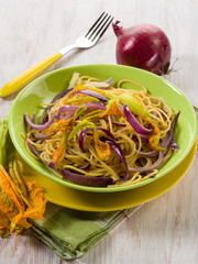 spaghetti with pumpkin flowers and onions