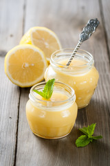 Obraz na płótnie Canvas Homemade lemon curd with fresh lemons
