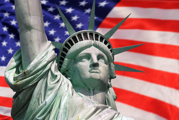 Statue of Liberty on Island in New York with flag of the USA