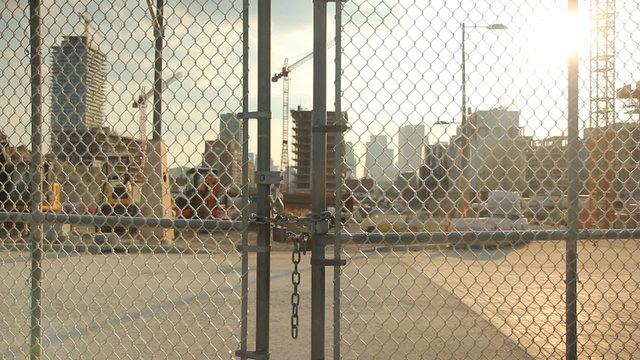 Locked gate at construction worksite. Shallow depth of field.