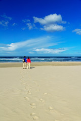 Happy couple on beautiful ocean beach, romantic vacation i