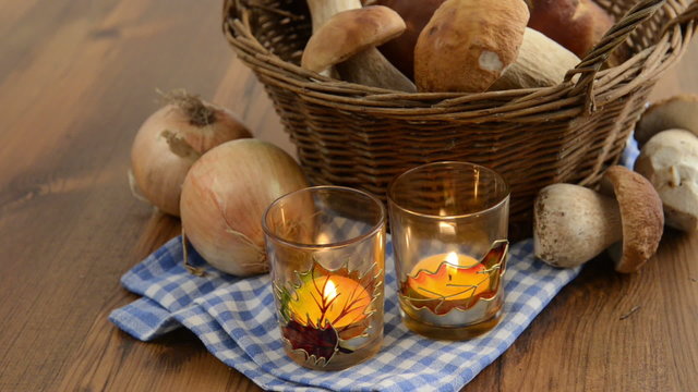 penny bun mushrooms in a basket and burning tea light