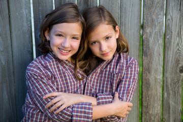 twin girls dressed up as siamese with his father shirt