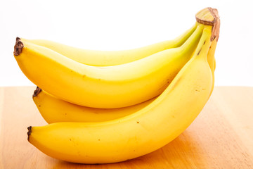 Bunch of Bananas on Wood Table with White Background