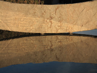 big stone reflection in water as background