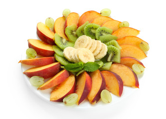 Naklejka na ściany i meble Assortment of sliced fruits on plate, isolated on white