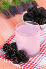 Fototapeta na wymiar Sweet blackberries with yogurt on table close-up