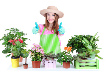 Beautiful girl gardener with flowers isolated on white