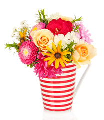 Beautiful bouquet of bright flowers in color mug, isolated © Africa Studio