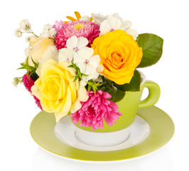 Beautiful bouquet of bright flowers in color mug, isolated