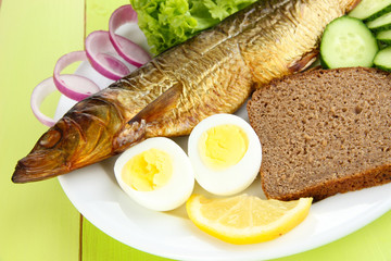Smoked fish on plate close up