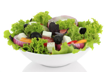 Greek salad on plate isolated on white