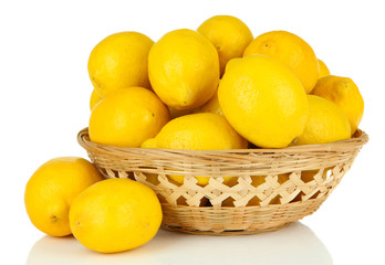 Ripe lemons in wicker basket isolated on white