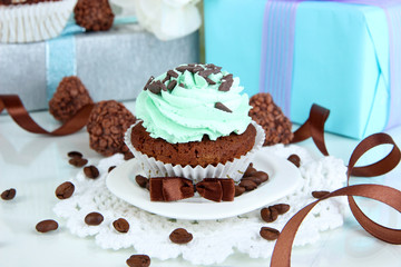 Tasty cupcake with gifts close up