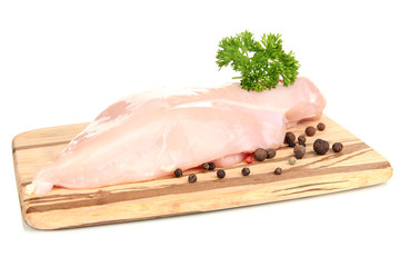 Raw chicken fillets on wooden board, isolated on white