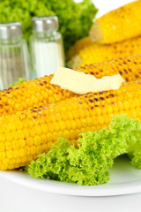 Delicious golden grilled corn with butter close-up