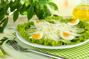 Delicious salad with eggs, cabbage and cucumbers on wooden