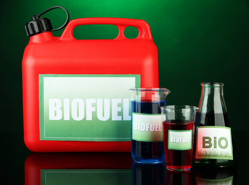 Bio fuels in canister and vials on green  background