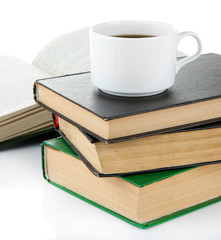 Cup of coffee and books isolated on white