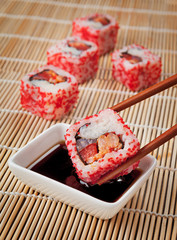 The concept of Japanese food - sushi and soy sauce on the mat