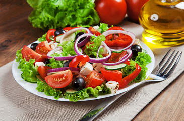The Greek and Italian food - fresh vegetable salad on the table
