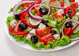 The Greek and Italian food - fresh vegetable salad on the table