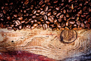 Coffee beans on old natural wooden background, macro. Brown Coff
