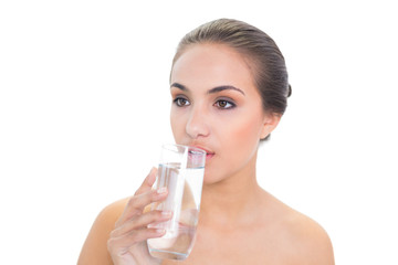 Lovely brunette woman drinking a glass of water
