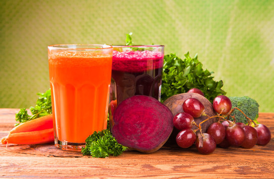 Fresh fruits, vegetables and juice isolated on wood