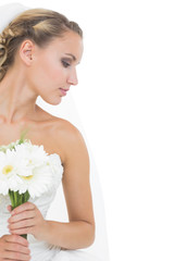 Obraz na płótnie Canvas Attractive blonde bride holding a bouquet