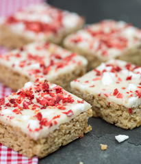 Strawberry and meringue topped flapjack on gingham cloth
