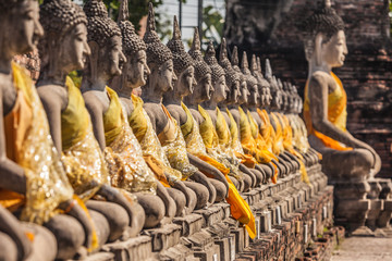 Naklejka premium Row of Buddha statues at the temple in Thailand